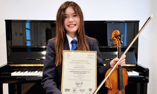 Ellie posing with her award and violin